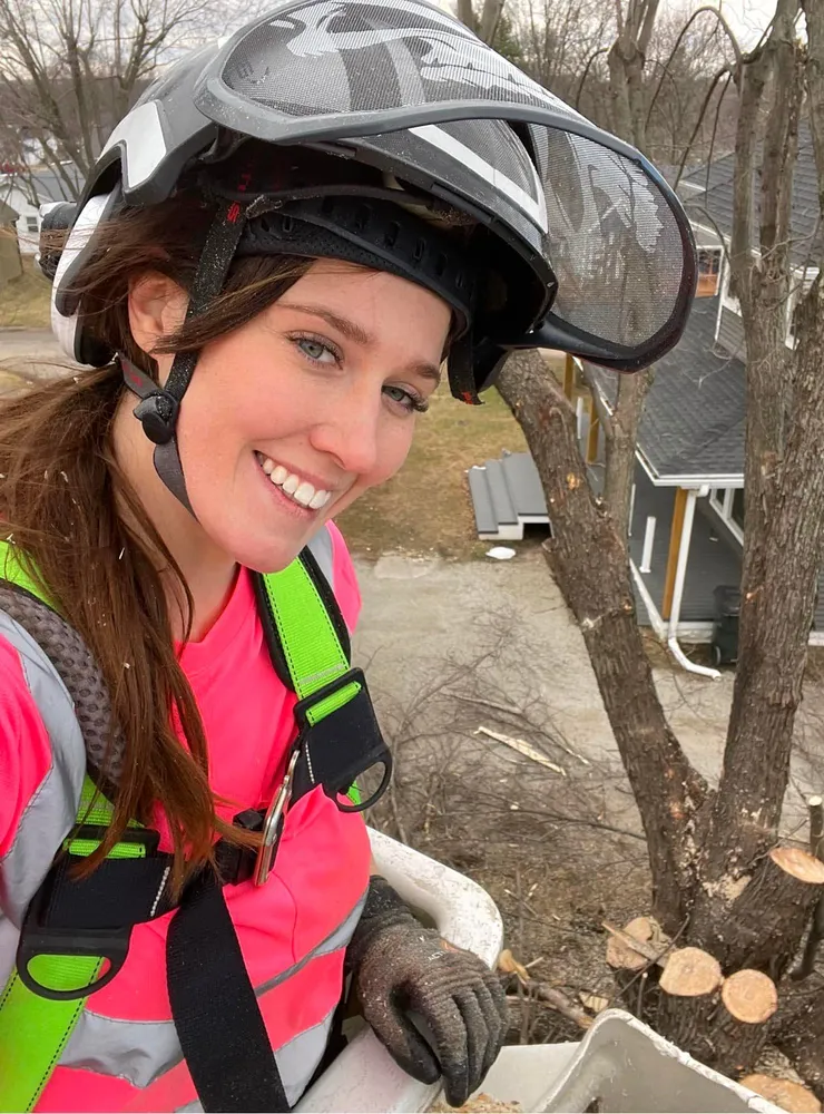 LumberJill Tree Service owner standing outdoors with work gear